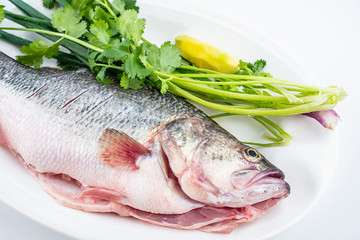 Cleaning chopped fresh salmon and ingredients