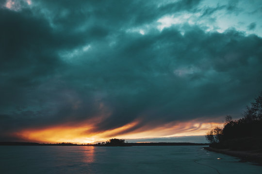 A picturesque sunset over a frozen lake.