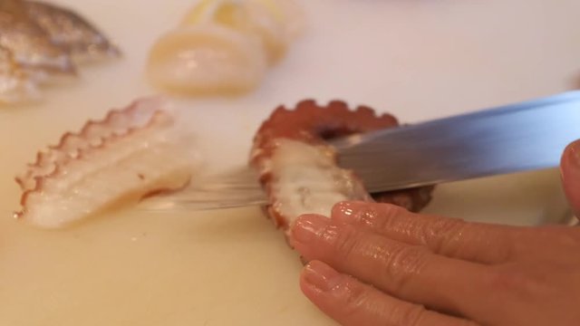Japanese chef use sharp knife slicing fresh fish for sashimi.  Squid, Salmon, Hotate