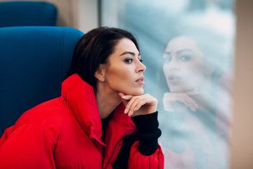 Beautiful female sitting  at train window