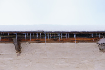 Icicles on the roof in winter, side view