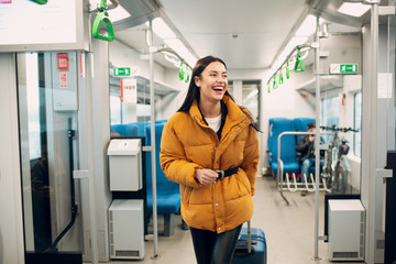 Young female walking and finding her seat in railway train.