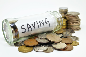 Saving lable in a glass jar with coins spilling out