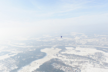 Fototapeta na wymiar Balloon on the background of the winter landscape