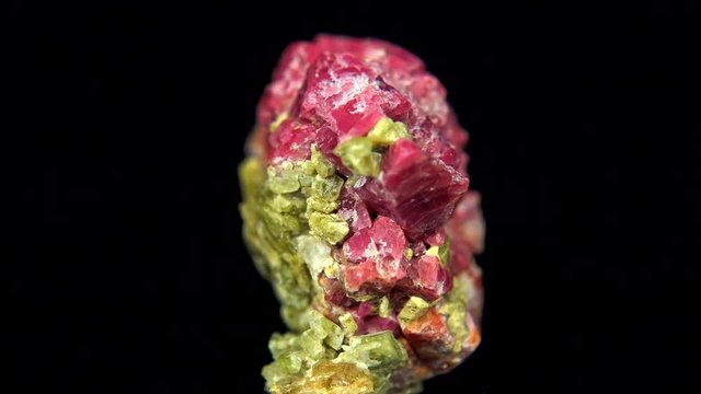 Seamlessly rotating a pink-lime mineral (Spinel Diopsid) in front of black background