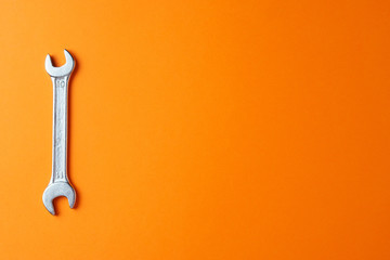 Metal key on an orange background