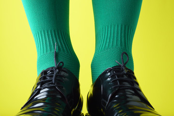 A man in green socks on a yellow background,  St. Patrick's Day