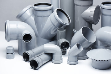 Plumbing, sewage. Gray polypropylene tubes on a white background in futuristic style