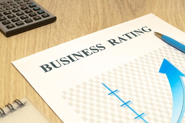 Business financial rating chart with pen and calculator.