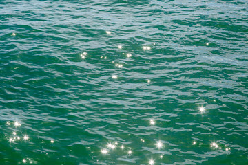 A full frame photograph of sunlight reflecting and shimmering on the ocean