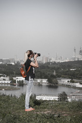 Woman traveler photographer make a photo of the city from the point of view