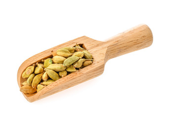 green cardamon isolated in wood scoop on white background