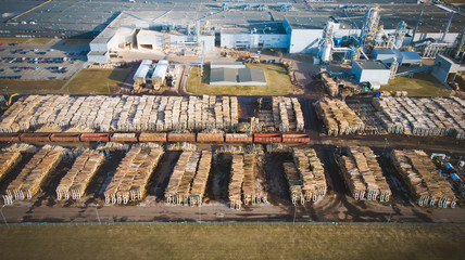Fototapeta premium Wood processing plant pollutes the air with smoke coming from the pipe. Aerial view.