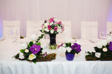 Bouquets of natural flowers on a white table. Background texture.