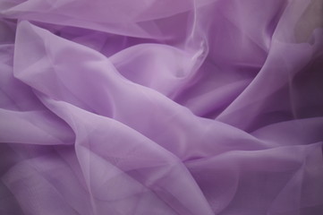 Purple fabric. Lilac textiles, rags violet cloth Photo background
