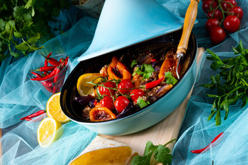Tasty spicy beef with various vegetables cooked in tagine