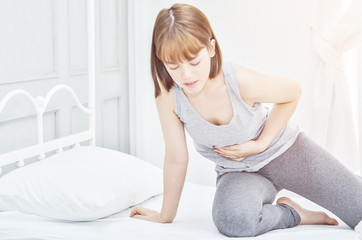Asian girl has abdominal pain.When is menstruation.Catch his stomach.Women have bladder pain.Do not...