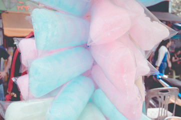 Candy made from sugar has a sweet taste and is mixed with food colors blue, green and pink for...