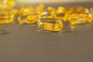 Gelatin capsules with the medicine are scattered across the table.