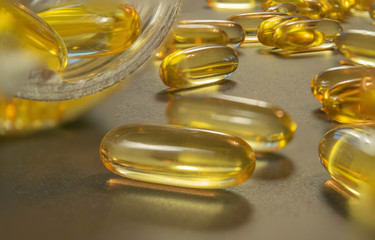 Gelatin capsules with the medicine are scattered across the table.