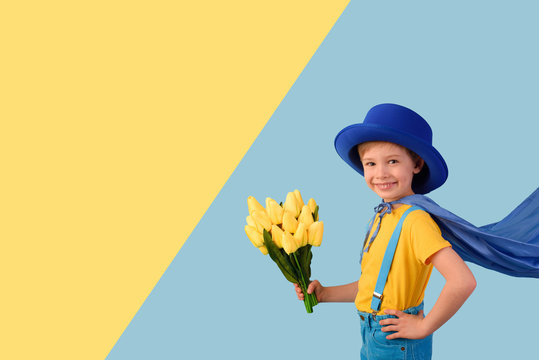 Little boy super hero holding flowers. Mother's Day, Women's Day concept.