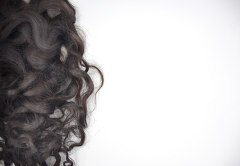 Dark brown curly hair on the white background
