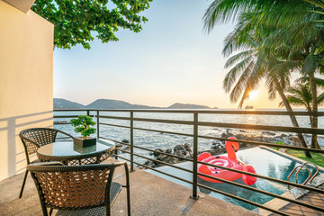 exterior swimming pool  ,floating swan  with sunset golden sky of ocean
