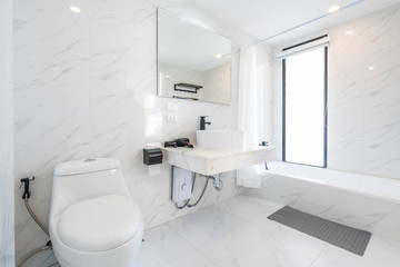 beautiful interior real white bathroom features basin and  toilet bowl