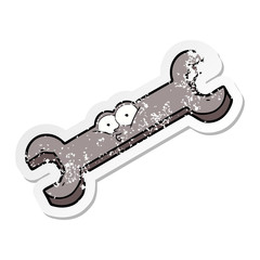 distressed sticker of a cartoon spanner