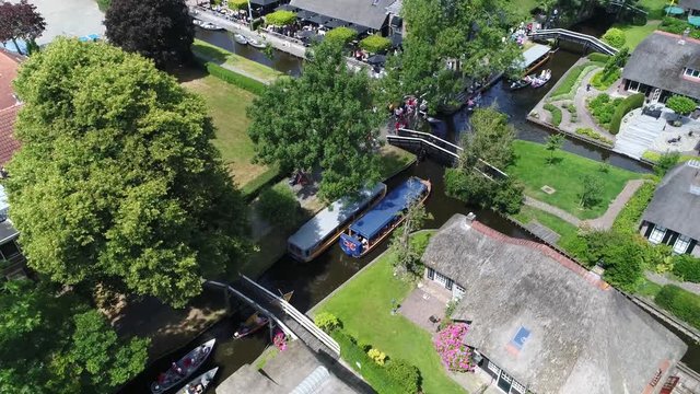 Aerial bird view footage of busy canals of Giethoorn is town in province of Overijssel Netherlands and a popular toruist destination also known as Little Venice showing the canal cruise boats queueing