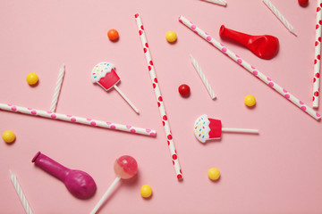 Carnival and party decor. Sweet candy, balloons, straw. Birthday background.
