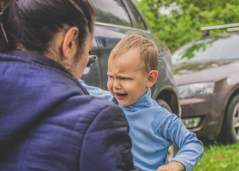 Naughty child make faces in front of mom