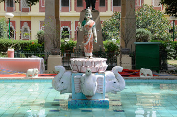 indian statue over pond