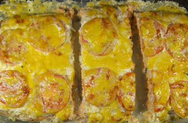 Obraz na płótnie Canvas Fish baked with cheese and tomatoes.