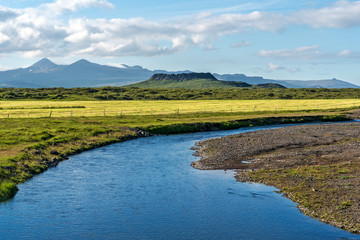 Kalda river flow in western Iceland and Eldborg volcano crater in the center of picture. © sasha64f
