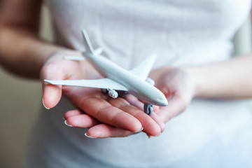 Female woman hands holding small toy model plane. Travel by plane vacation weekend adventure trip journey ticket tour aviation delivery concept. Symbol of international freedom