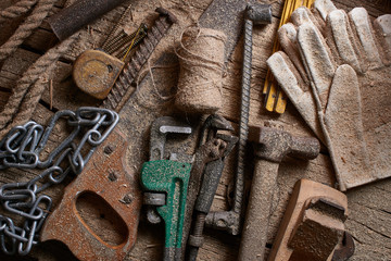 DIY, a pile of old work tools and accessories on a wooden table in the workshop. Do It Yourself concept.