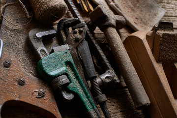 DIY, a pile of old work tools and accessories on a wooden table in the workshop. Do It Yourself concept.