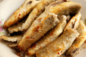 A lot of fried fish. Cod fish fried to a golden crust. Cooked navaga in a big pile. Fish in the kitchen.