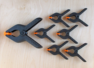 One 6 inch (150 mm) and six 3.5 inch (90 mm) black nylon spring clamps with orange nibs on a...