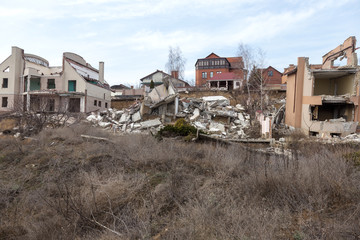 Landslide caused by rains of hurricane destroyed expensive cottages and houses. Destroyed house, cottage, large cracks, chips, slabs. Broken asphalt shifted landslide after earthquake. View from drone