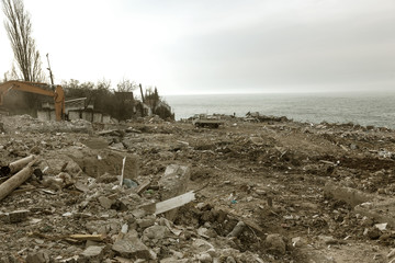 Landslide caused by rains of hurricane destroyed expensive cottages and houses. Destroyed house, cottage, large cracks, chips, slabs. Broken asphalt shifted landslide after earthquake. View from drone