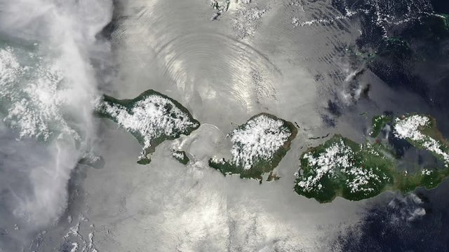 Clouds moving over Gili Island in Lombok strait, satellite view. Contains public domain image by Nasa