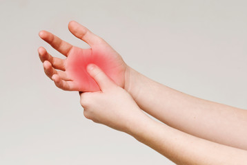 Woman massaging hand to stop palm ache