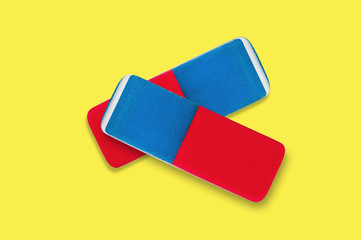 Pair of rectangular rubber erasers for pencil and pen ink in center on yellow background