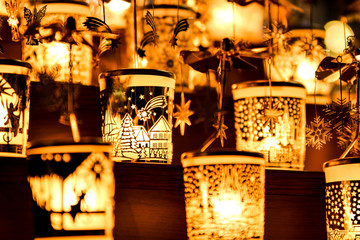 A detail picture of the golden candle holders with lighted candles during the christmas season. 