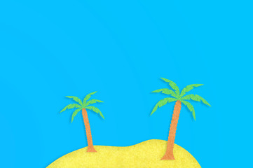 Two palm trees with leaves and yellow island cut out from paper on blue table. Top view. Minimalism concept - Image. Copy space for your text