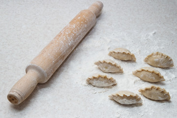 Appetizing dumplings, vareniki, ravioli, momo close-up. Boiled dough with filling. Traditional dish of Ukraine, Italy, Asia. Dumplings with meat, fish, vegetables. A hearty breakfast, lunch, dinner.