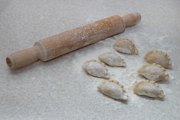 Appetizing dumplings, vareniki, ravioli, momo close-up. Boiled dough with filling. Traditional dish of Ukraine, Italy, Asia. Dumplings with meat, fish, vegetables. A hearty breakfast, lunch, dinner.
