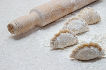 Appetizing dumplings, vareniki, ravioli, momo close-up. Boiled dough with filling. Traditional dish of Ukraine, Italy, Asia. Dumplings with meat, fish, vegetables. A hearty breakfast, lunch, dinner.